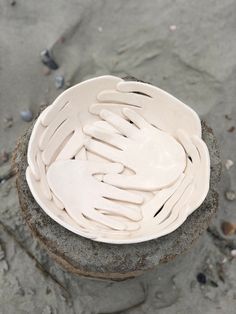 a white bowl sitting on top of a rock