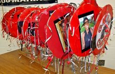 a group of red heart shaped frames hanging on a wall