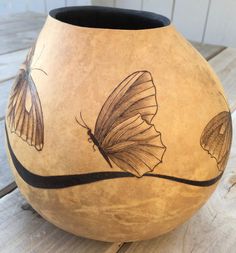 a vase with two butterflies painted on it