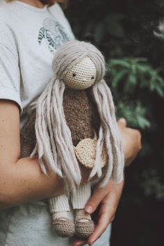 a person holding a stuffed animal in their hands