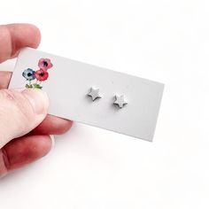 These sweet little studs are crafted from sterling silver and are simply adorable. Earrings measure 7mm (please make note of the size: these are smaller than traditional bel monili creations!) and are lightweight and comfortable to wear. Simple Sterling Silver Cartilage Earrings Gift, Simple Small Silver Earrings, Simple Tiny Silver Cartilage Earrings, Cute Silver Jewelry With Star Charm, Dainty Silver Star Cartilage Earrings, Cute Silver Star Jewelry, Dainty Star Cartilage Earrings Gift, Sterling Silver Earrings With Star Charm, Minimalist Silver Star Cartilage Earrings