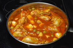 a pan filled with food sitting on top of a stove