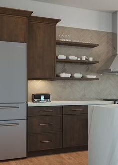 a modern kitchen with wooden cabinets and stainless steel appliances, including a refrigerator freezer