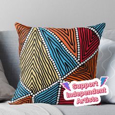 a colorful pillow with the words support independent artists on it