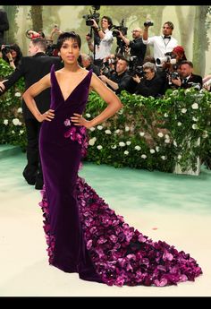 a woman in a purple gown with flowers on it