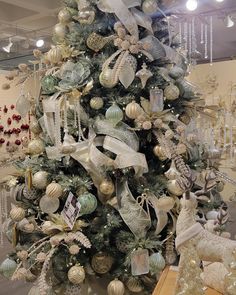 a christmas tree decorated with ornaments and ribbons