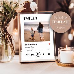 a table that has some flowers and candles on it with a photo frame next to it