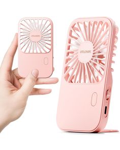 a hand holding an electronic device with a fan on it's side and the phone case open