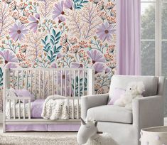 a baby's room decorated in pastel colors and floral wallpaper, with a rocking chair next to the crib