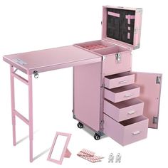 a pink desk with drawers and other accessories