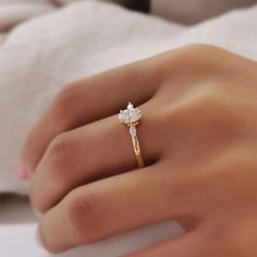 a woman's hand with a diamond ring on it