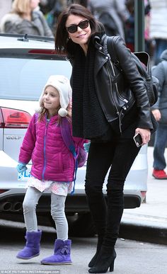 the mother and daughter are walking down the street