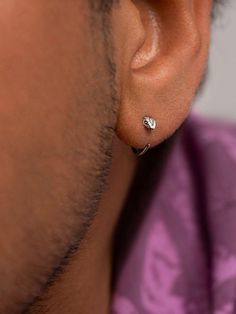 a man wearing a pair of ear piercings