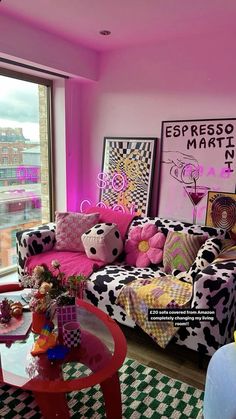 a living room with pink walls and black and white checkered rugs on the floor