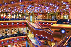 the inside of a cruise ship with many escalators