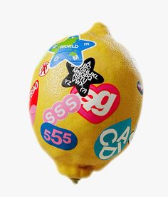 a large lemon with stickers on it