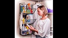 a woman standing in front of a rack with items on it and looking at her phone