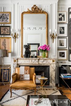 a living room filled with furniture and a large mirror above a fireplace covered in pictures