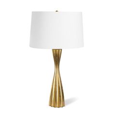 a gold lamp with a white shade on the top and bottom part of the lamp