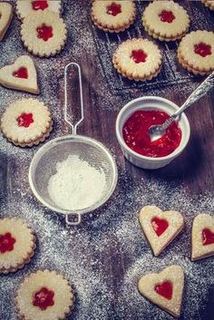 heart shaped cookies are being made with icing