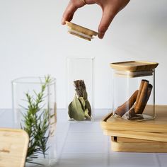 This Stackable Glass Canister with Bamboo Lid 2-pack is the perfect solution for organizing your spice rack and countertops while keeping your foods fresh. Made from high-quality borosilicate glass, this canister with a bamboo lid is durable, stylish, and versatile. It's square shape makes it easy to make the most of whatever space you have available, with a subtle lip on the lid that prevents stacked canisters from slipping and sliding off. Use it to store dry goods and spices like bay leaves, cinnamon sticks, peppercorns, and more - and eliminate plastic from your kitchen in the process! Copper Bakeware, Food Dispensers, Induction Oven, Boho Vase, Wood Utensils, Baking Utensils, Silicon Utensils, Glass Canisters, Slip And Slide