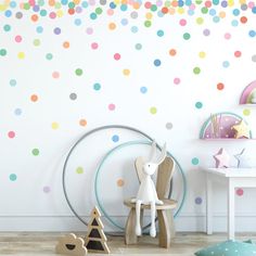 a child's room with polka dot wallpaper and wooden toys on the floor