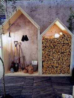 two small houses made out of wood stacked on top of each other with tools in them