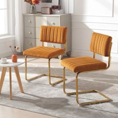 two orange chairs sitting next to each other on top of a white carpeted floor