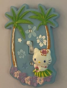 a hello kitty light switch cover with palm trees