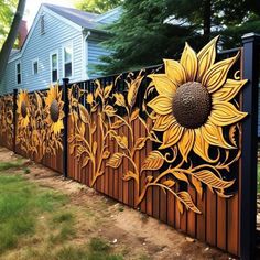 a sunflower painted on the side of a fence