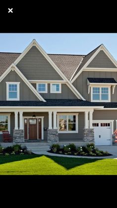 a large house with two garages and three windows