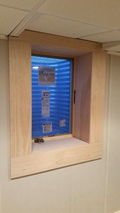 an empty room with blue walls and papers on the window