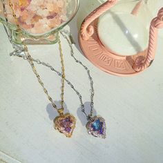 A whimsical and dainty piece that looks as if it was plucked from the pages of a fairy tale. The Fae Heart Necklace features a mesmerizing stone that beautifully shifts colors in the play of light. Wear it and let your heart shine with every enchanting hue, a true symbol of magic and wonder. For the days when your heart seems trapped in a cage, and simply getting out of bed feels like a heavy wage.... I hope you look for the light within you trying to burst through, because, like fairies, we carry diamonds in our hearts too. lab created diamond with magenta and teal hues incased in cubic zirconia studded gold/silver molding chain measures 16 inches + 2 inch extender clasp gold/silver plated stainless steel, non-tarnish and waterproof chain The Fae, A Fairy Tale, Silver Heart Necklace, Getting Out Of Bed, Lab Created Diamonds, Fairy Tale, Heart Necklace, Fairy Tales, Silver Gold