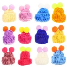 several knitted hats with different colored pom poms