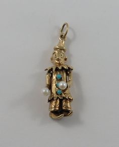 "This is a vintage mechanical \"Clown With Turquoise & Pearl Stones\" 10 karat gold charm for a charm bracelet. The clown has movable limbs including head/neck, legs, feet and arms (arms move together). There is a pearl stone on each of the clowns hand and three turquoise stones along the torso.   It weighs 6.35 grams and measures 1/2\" x 1 1/4\", marked \"10K\" All charms come with a split ring to attach to a bracelet. We have hundreds of charms in stock. If you don't see what you are looking f Turquoise Charm, Pearl Stone, White Stones, Head And Neck, Gold Charm, Turquoise Stone, 10k Gold, Vintage Charms, Amazing Jewelry