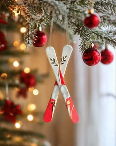 two pairs of skis hanging from a christmas tree