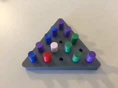 a triangle shaped board game sitting on top of a table