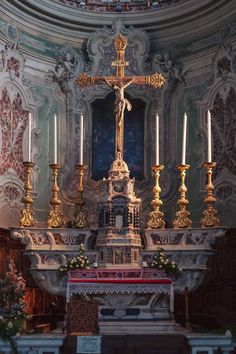 an ornate alter in a church with candles lit