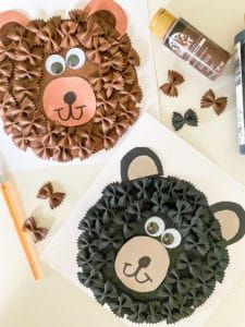 two paper plates with animal faces on them next to some crafting supplies and glue