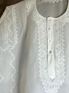 Hand embroidered classic round neck cotton kurta for men. "Size mentioned is the actual garment measurement" Eid Straight Kurta With Tonal Embroidery, Embroidered Cotton Kurta For Traditional Ceremonies, Ceremonial Cotton Embroidered Kurta, Ceremonial Cotton Kurta With Chikankari Embroidery, Traditional Cotton Kaftan With Embroidered Border, Embroidered White Kaftan For Transitional Season, Traditional Fit White Top, Transitional White Embroidered Kaftan, Folk Style Cotton Kurta For Traditional Ceremonies