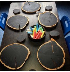 a table topped with lots of cut up pieces of wood next to colorful candy sticks