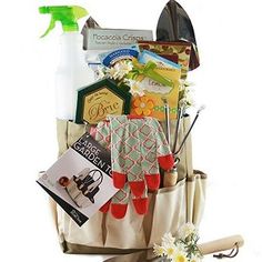 the garden gift basket contains gardening tools, flowers, and other personal care items for gardener's