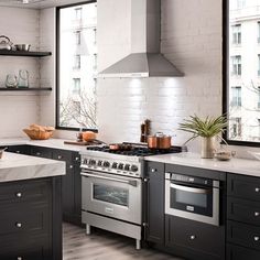 a kitchen with an oven, stove and counter tops in black and white color scheme