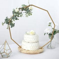 This decorative cake display stand will create an eye-catching look for your party tables. Featuring a geometric metal hoop with natural wood base, this stylish and functional display stand can be used in several ways. Use it to present your cupcakes, desserts and sweet treats in style. Make it a base for your flowers, greenery, candles or any centerpieces. The metal arch can be accented with LED lights or garlands to add charm to your dessert station. The possibilities are endless! This cake st Metal Cupcake Stand, Arch Cake, Metal Cake Stand, Wood Cake Stand, Cake Stand Display, Dessert Station, Special Events Decor, Stand Table, Metal Arch