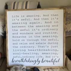 a wooden framed sign that reads, life is amazing and then it's amazing again