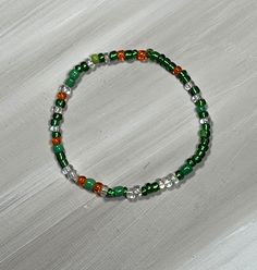 Green bead bracelet, perfect for older children and teens. stretch bracelet comes in two color combos; shiny beads or matte beads. This color variation is great for St Patricks Day. bracelet is available in several sizes. comes ready to gift with organza bag and gift card.   Mix and match multiple colors to wear together! Trendy Green Hypoallergenic Beaded Bracelets, Green Casual Beaded Bracelets With Spacer Beads, Casual Green Beaded Bracelets With Spacer Beads, Trendy Green Stretch Bracelet Suitable As Gift, Casual Elastic Beaded Bracelets As Gift, Trendy Green Beaded Bracelets, Trendy Green Round Beaded Bracelets, Casual Green Bracelets With Spacer Beads, Casual Green Bracelet With Spacer Beads