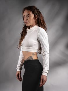 White cyberpunk crop top with long sleeves. Edgy and unique design inspired by Sci Fi.  KEY FEATURES - Special neckline - for an edgy look; - Made with special stretchy threads - Qualitative dense jersey fabric. - Labels are sewn on separately so you can remove them without damaging the garment. SIZE & MEASUREMENTS All sizes are given in the last picture. The fabric is stretchy. If you aren't sure about the size, add your bust, waist, hips, and height measurements as a note. FABRIC: White textur Stretch Punk Crop Top For Streetwear, Punk Style Long Sleeve Stretch Crop Top, Edgy Stretch Crop Top For Alternative Fashion, Long Sleeve Crop Top For Club, White Stretch Edgy Crop Top, Edgy White Stretch Crop Top, Fitted Crop Top For Club In Winter, Fitted Winter Crop Top For Club, Edgy Long Sleeve Crop Top For Club