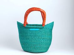 Take the beach with you with our intricately handwoven totes, made in Bolgatanga, Ghana by our talented artisans. Perfect for an overnight stay, brunch, the beach, the market or any occasion. Body woven with straw and elephant grass Handles 100% leather Made in Ghana *Each tote is handmade so no two are alike...dimensions vary Mini Tote Colors in stock: Turquoise Red Black Fuschia Yellow Apple Green Orange Purple Multi Print Classic 1 Tote Colors in Stock: Solid Red Solid Black Solid Navy Solid Yellow Solid Fuschia Solid Tan Akataasia Colors in Stock: Green Yellow Fuschia Navy Orange Tan Natural Fiber Beach Bag In Bucket Shape For Market, Natural Fiber Bucket Beach Bag For Market, Fair Trade Basket Beach Bag, Fair Trade Beach Basket Bag, Casual Fair Trade Bucket Beach Bag, Fair Trade Basket Beach Bag Made Of Natural Fiber, Casual Straw Bag With Rolled Handles For Market, Eco-friendly Handwoven Bucket Bag For Market, Fair Trade Bucket Beach Bag For Summer