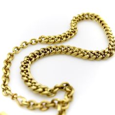 This is part of Chairish’s Fine Jewelry assortment.  This 14k gold watch chain has a fabulous hollow link interwoven with tiny balls for an unusual variation of a curb link. The links are carved with a ribbed texture that give a matte surface to the gold. This creates a unique visual texture that almost gives the illusion that the lines of the chain are blurry or out of focus. The tiny balls add a vertebrae-like element that reinforces the chain and make its movement serpentine.   At each end of Formal Wheat Chain Link Necklace, Luxury Link Chain Necklace With Wheat Chain Detail, Luxury Link Chain Necklace With Wheat Chain, Luxury Wheat Chain Link Necklace, Victorian Gold Chain Necklace With Oval Links, Formal Engraved Chain Link Necklace, Gold Engraved Oval Link Chain Necklace, Engraved Chain Link Necklace For Formal Occasions, Formal Engraved Link Chain Necklace