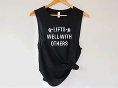 a black shirt with white writing on it that says, life is a well with others